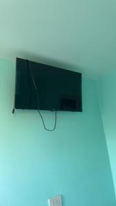 a flat screen tv hanging on a wall at BAN SUAN KRATOM CAFE AND RESORT in Nakhon Pathom
