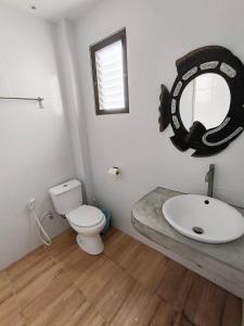 a bathroom with a sink and a toilet and a mirror at Sairee View Resort in Koh Tao