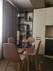 a dining room with a table and pink chairs at CosHOME - apartament in Chişinău