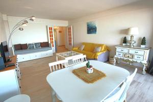 a kitchen and living room with a table and a couch at Apartment Seaside in Cannes +6 photos