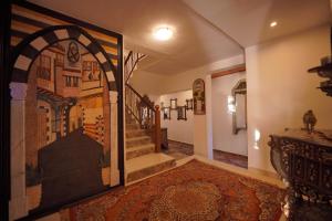 a hallway with a painting of a staircase in a house at Petra Plaza Hotel in Wadi Musa
