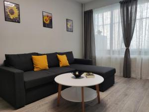 a living room with a couch and a table at Maya's Airport Apartment in Sofia +37 photos