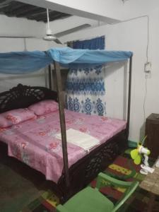 a bedroom with a bunk bed with a canopy at Tabassam Guest House in Lamu