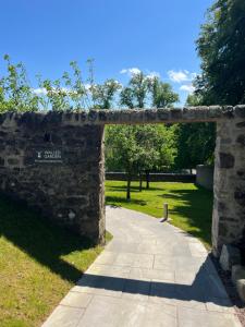 an archway over a path in a park at The Old Manse of Blair, Boutique Hotel & Restaurant in Blair Atholl