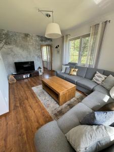 a living room with a couch and a coffee table at Leśne Dziarnówko in Iława