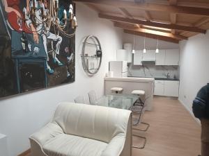 a living room with a white couch and a glass table at Apartamento Café Teatro in Arzúa