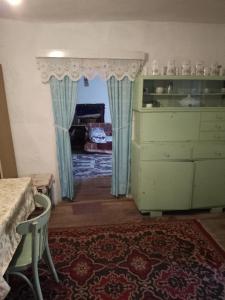 a room with a dresser and aoire with blue curtains at Casa la tara Lucia in Eibenthal