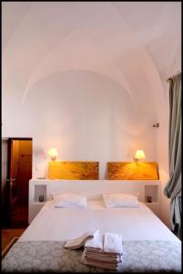 a bedroom with a white bed with two towels on it at Casa de Pedrógão in Pedrógão +33 photos