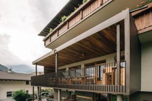 an external view of a house with a deck at Hotel Wildschütz in San Leonardo in Passiria