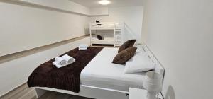 a white bedroom with a large bed in a room at Vila Ibrahimovic Vodice in Vodice +29 photos