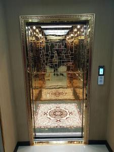 a gold mirror in a room with a rug at Sharq Plaza in Bukhara