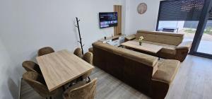 a living room with a couch and a table at Vila Ibrahimovic Vodice in Vodice