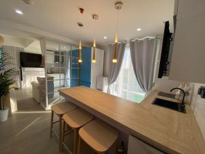 - une cuisine avec un comptoir et des tabourets dans une pièce dans l'établissement Muji Inspired Beach view, à San Fernando
