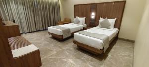 Postel nebo postele na pokoji v ubytování HOTEL ARCHANA RESIDENCY