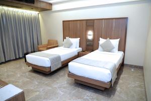 Postel nebo postele na pokoji v ubytování HOTEL ARCHANA RESIDENCY