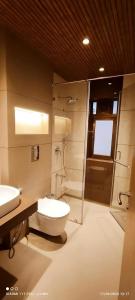 a bathroom with a toilet and a sink and a shower at HOTEL ARCHANA RESIDENCY in Mumbai