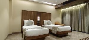 Postel nebo postele na pokoji v ubytování HOTEL ARCHANA RESIDENCY