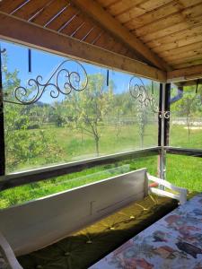 a window in a bedroom with a view of a field at Карпатська Мавка in Vorokhta