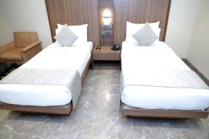 Postel nebo postele na pokoji v ubytování HOTEL ARCHANA RESIDENCY