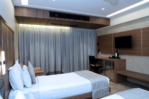 Postel nebo postele na pokoji v ubytování HOTEL ARCHANA RESIDENCY
