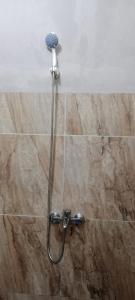 a shower in a bathroom with a shower head at Mutiara Homestay Jogja in Ngingas