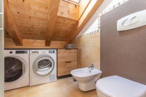 a bathroom with a washing machine and a sink at Arabba - Al Vecio Soler in Livinallongo del Col di Lana +20 photos