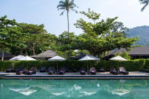 a swimming pool with lounge chairs and umbrellas at GajaPuri Resort Koh Chang in Ko Chang