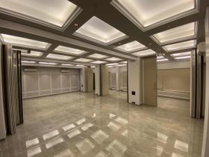 a large room with ceilings and a tile floor at J Hotel and Banquets in Mumbai