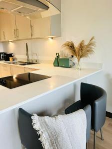 a kitchen with a sink and a counter at Luxurious & Spacious 2 Bed Apartment- Private Parking in Kent