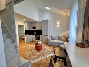 a living room with a couch and a table and chairs at Joli duplex, coeur du Pouliguen in Le Pouliguen +11 photos
