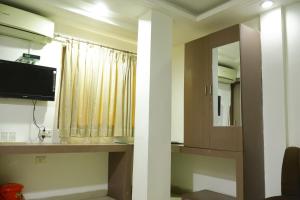a bathroom with a sink and a mirror at Hotel Neelkanth , Bhopal in Bhopal