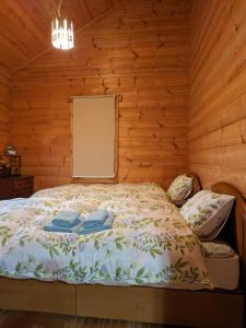 a bedroom with a bed in a wooden cabin at Log Cottage be with nature in Furano