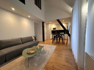a living room with a couch and a table at Charmant duplex au Pouliguen in Le Pouliguen