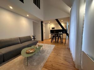 a living room with a couch and a table and a piano at Charmant duplex au Pouliguen in Le Pouliguen +18 photos