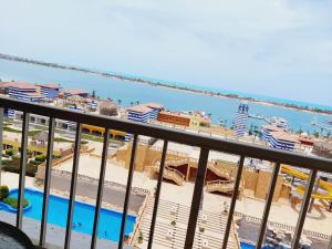 a view from a balcony of a resort and the ocean at شاليه سي فيو بورتو مارينا عائلات - Porto Marina Sea View in El Alamein