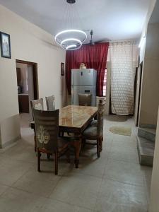 a dining room with a table and chairs at Div's luxurious homestay in Jaipur