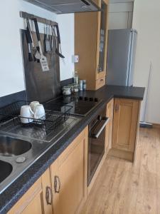 a kitchen with a sink and a counter top at Aughnahoy Staycations Portglenone in Portglenone