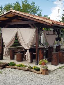 a pavilion with a canopy with flowers and plants at B&B MON AMOUR 