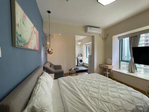 深圳LaCave公寓 في شنجن: غرفة نوم مع سرير وغرفة معيشة