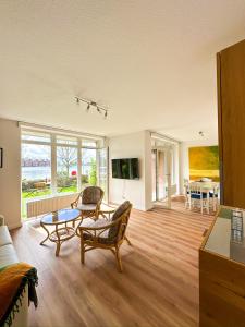 a living room with a couch and a table at Ferienwohnung Havenblick in Wilhelmshaven +28 photos