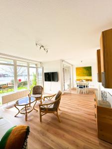 a large living room with a table and chairs at Ferienwohnung Havenblick in Wilhelmshaven +28 photos