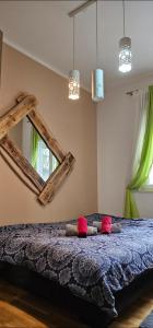 a bedroom with a bed with a large mirror at Apartman Kalina in Novi Sad