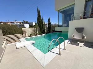 a swimming pool in the backyard of a house at RVG Jenny House with pool in Porto Heli