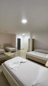 a bedroom with two beds and a room with at Hotel Skura in Librazhd