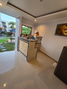 a kitchen with a counter and a view of a yard at The Lucky Canggu 2 in Canggu