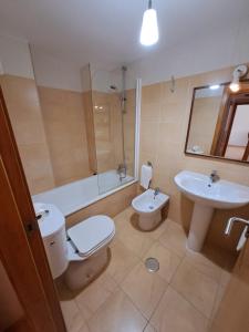 a bathroom with a toilet and a sink at Apartamentos Punta Cormorán V.v. in La Manga del Mar Menor