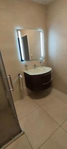 a bathroom with a sink and a mirror at Studio de vacances in Crémines