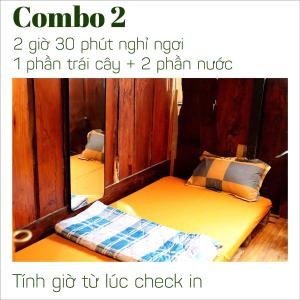 a room with two bunk beds and a mirror at The GK House Hostel, Ecolliving, central city, natural wooden, chill view rooftop, reétaurant and cocktail bar in Ho Chi Minh City