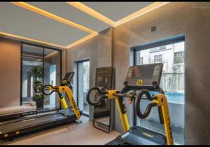 a gym with two tread machines and a treadmill at Yihe Riverside Suzhou in Suzhou