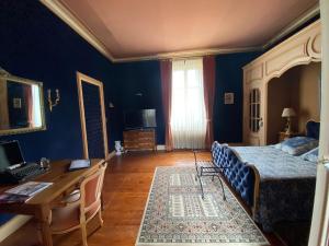 a bedroom with a bed and a desk and a desk at LE CHATEAU Ste MARIE in Fors